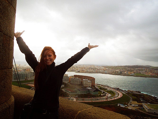 Student posing in front of view of a city below