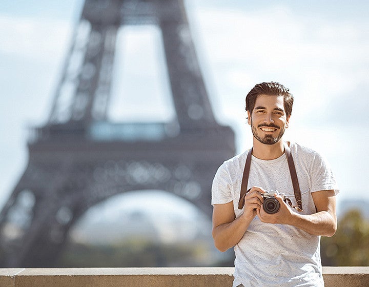 Paris Eiffel Tower tourist with camera taking pictures in front of the Eiffel tower, Paris, France