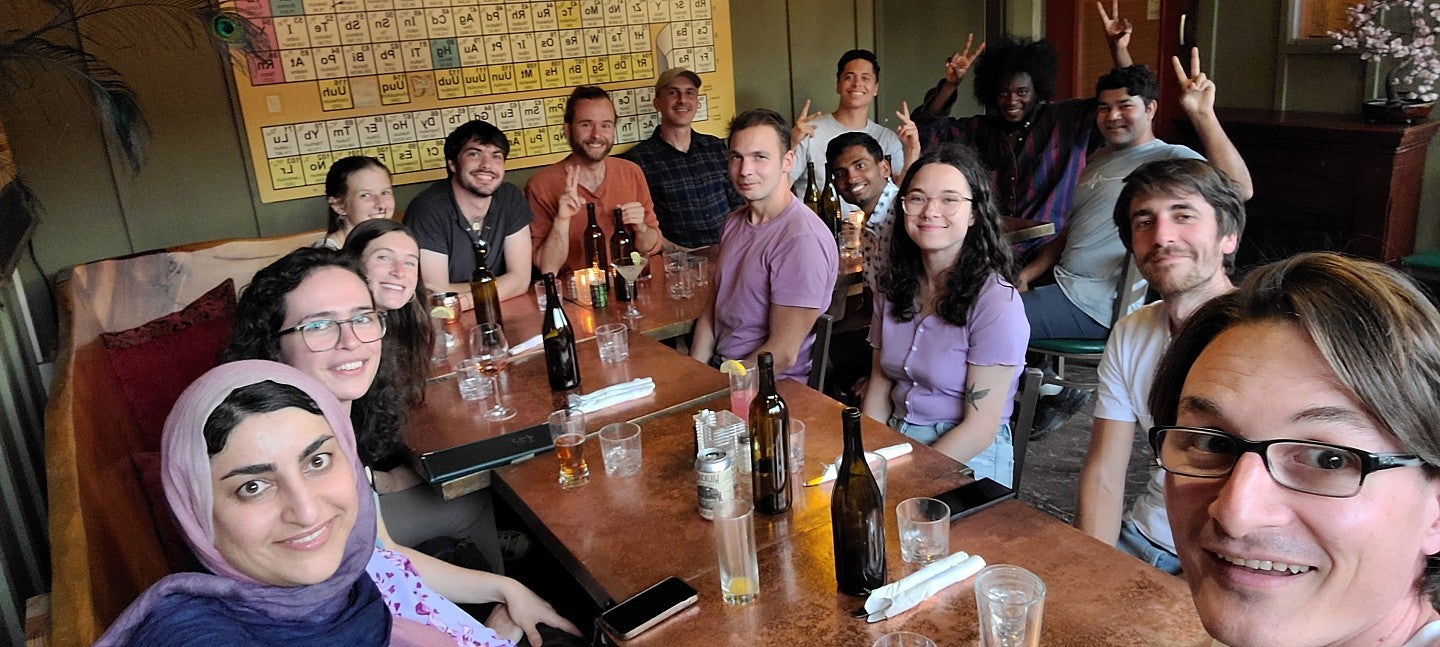 a group of people posing together at a restaurant