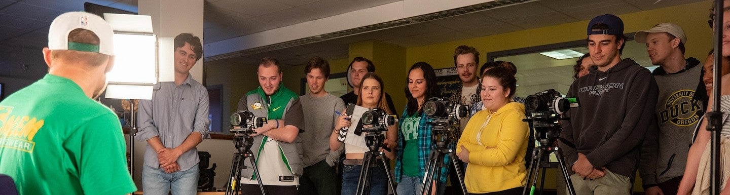 a group of students behind cinema cameras and lights