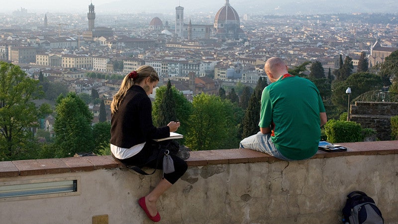 Siena, Italy (two students sketching/writing at sunset)