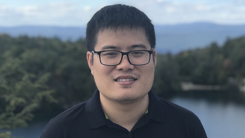 Thien Huu Nguyen posing with a lake in the background