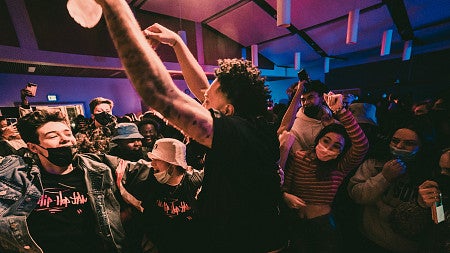 Students cheer around a man at a party