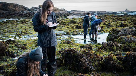 Biology students take samples outside 