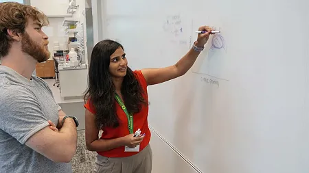 Marian Hettiaratchi writing on a whiteboard