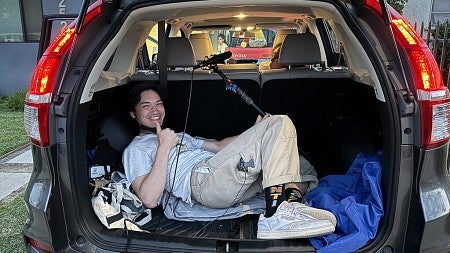 a person laying down in a SUV trunk