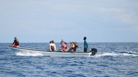 a boat on the horizon of a body of water