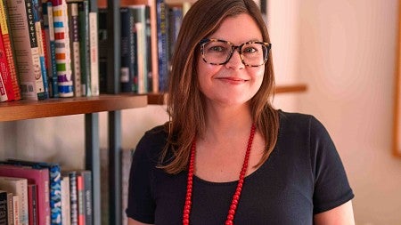 Karen Thompson Walker poses in front of a bookshelf