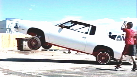 white lowrider hopping up in the air with hydraulics 