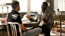 Two people having a discussion in an office setting.