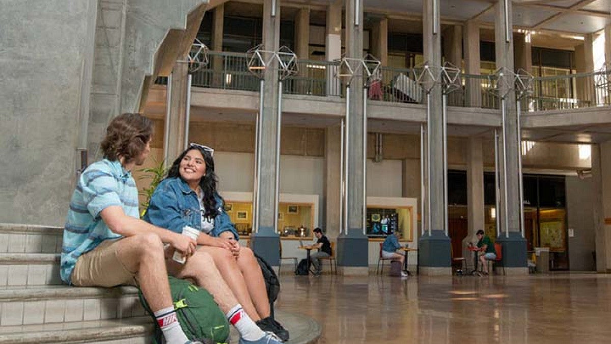 two students sitting on steps