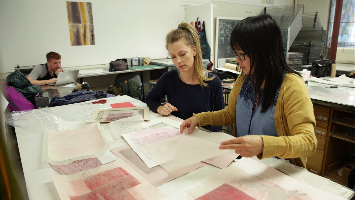 two people reviewing documents in art class