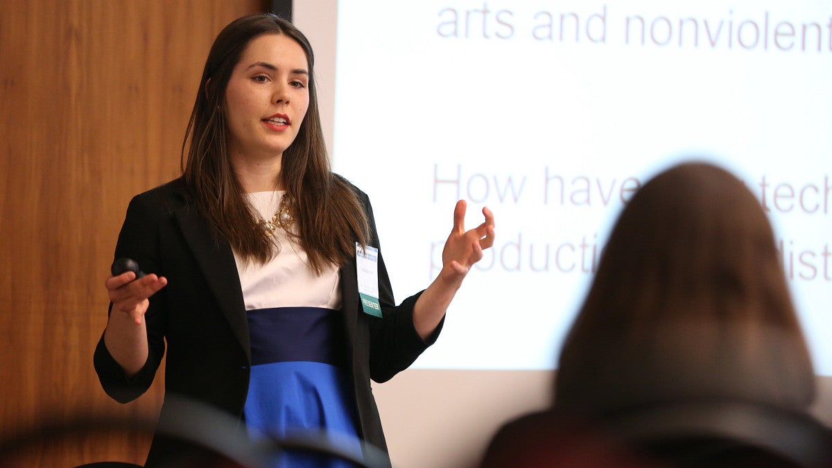 student presenting in the front of the room