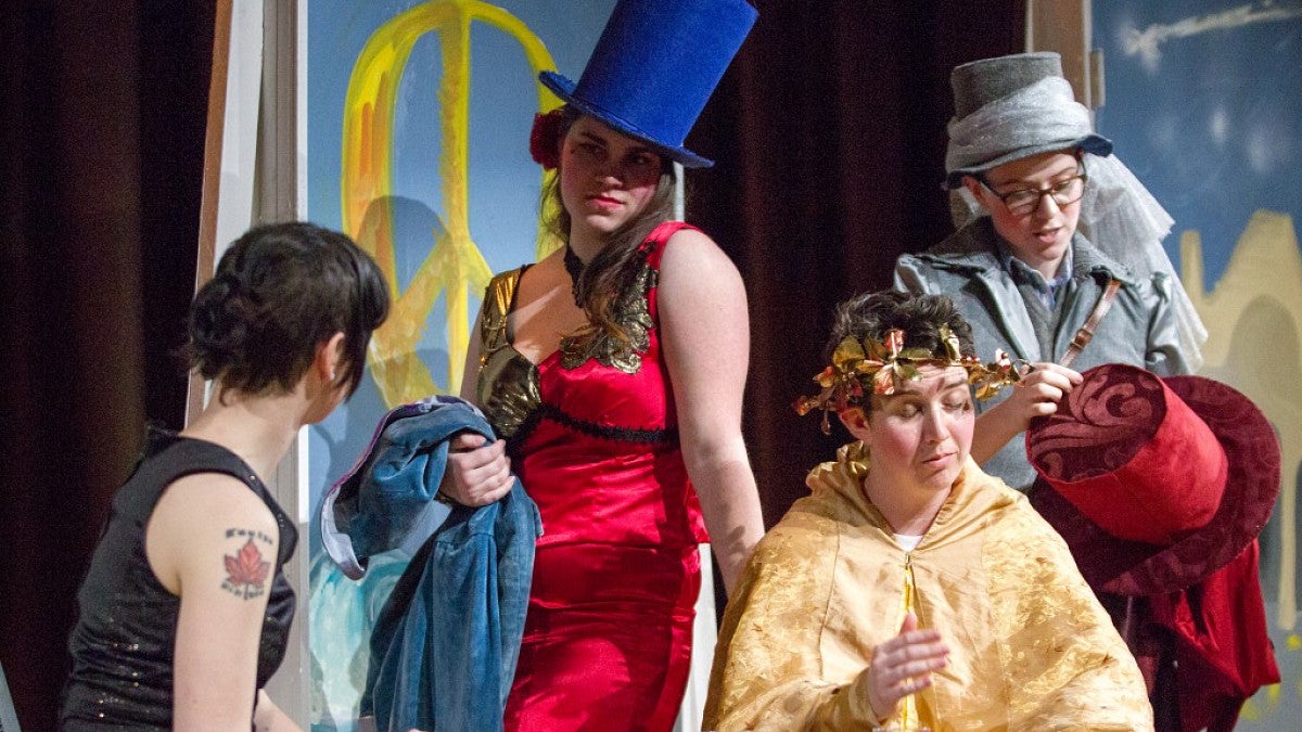 Students in costume on stage