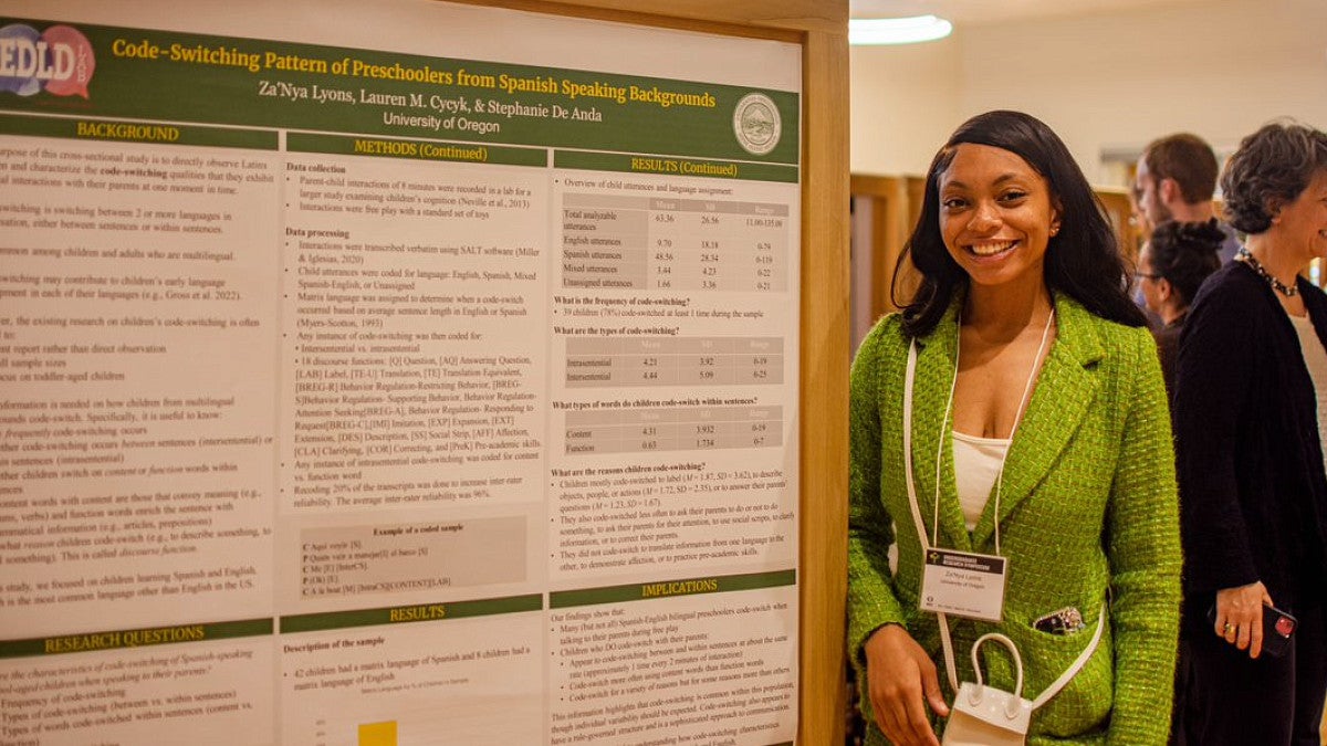 Student standing in front of project