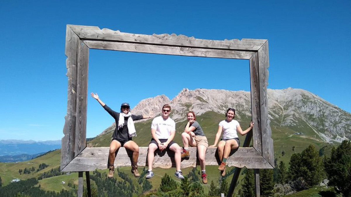 Students posing in front of mountain
