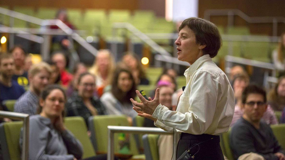 Woman speaking to class of student