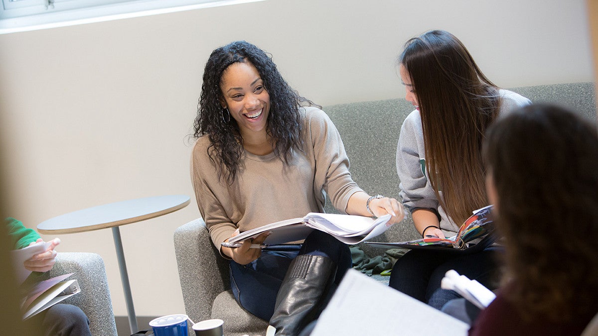 Graduate students engaged in group discussion