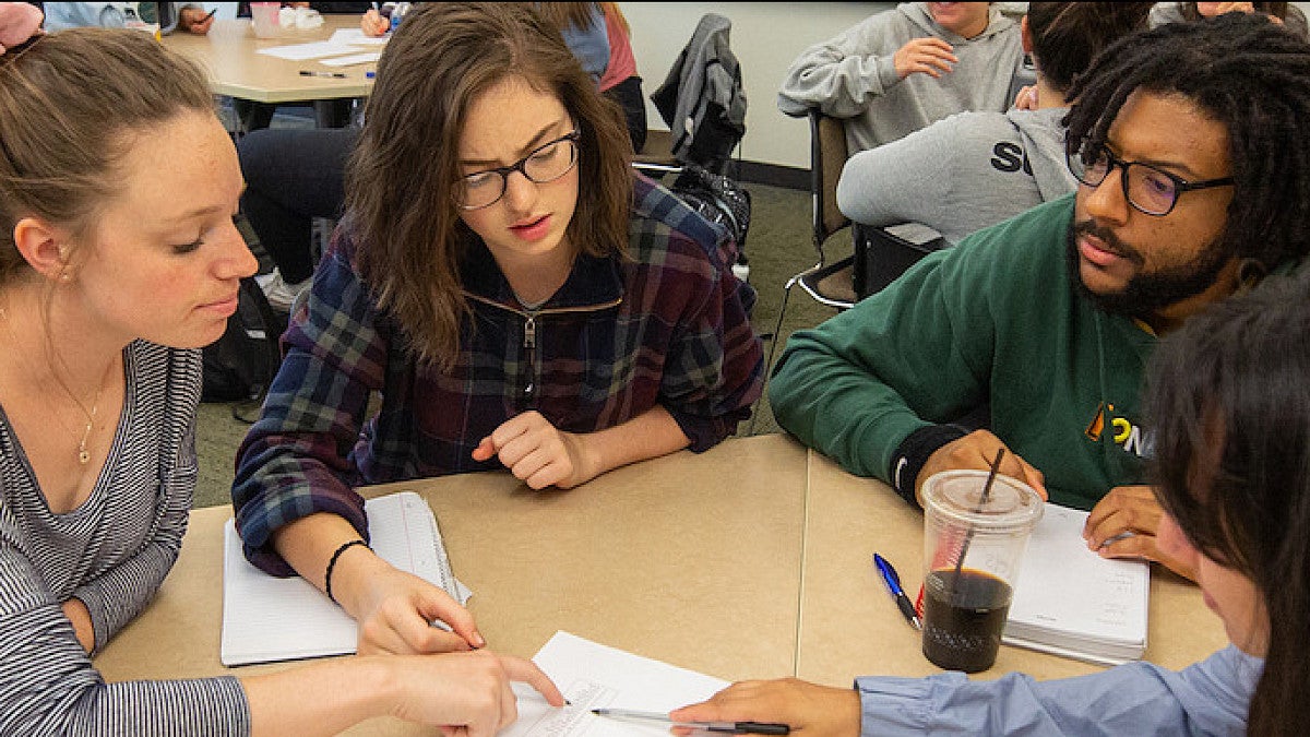 Students talking at desk