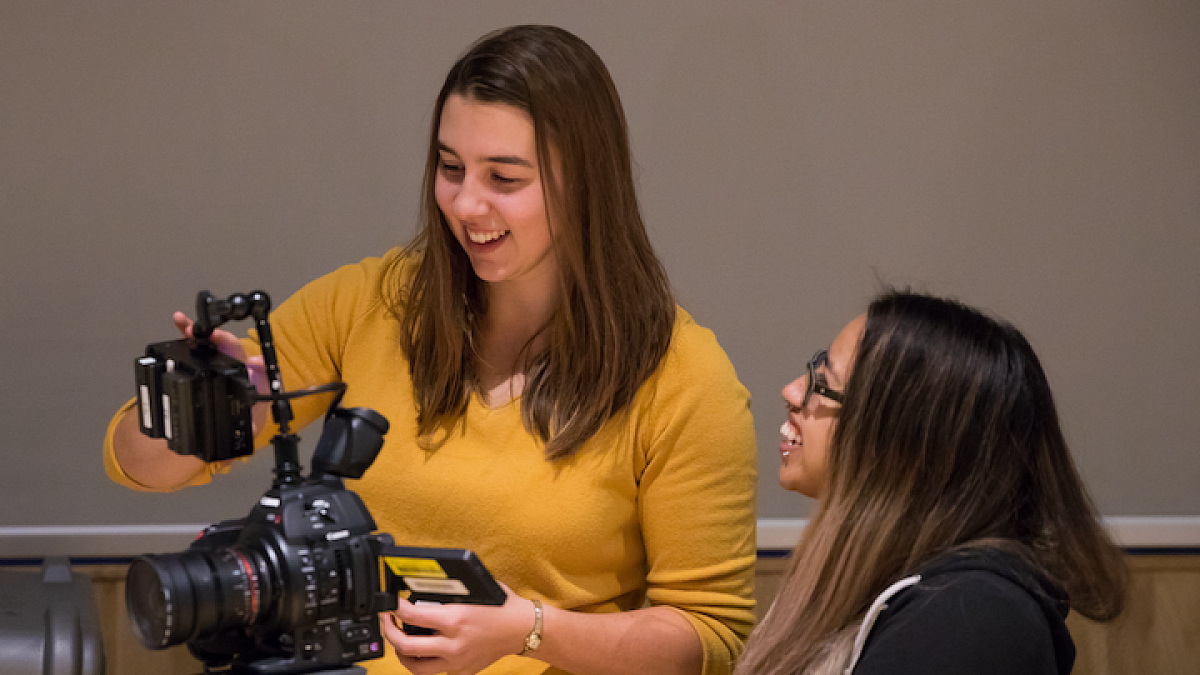 students praticing using camera for filming