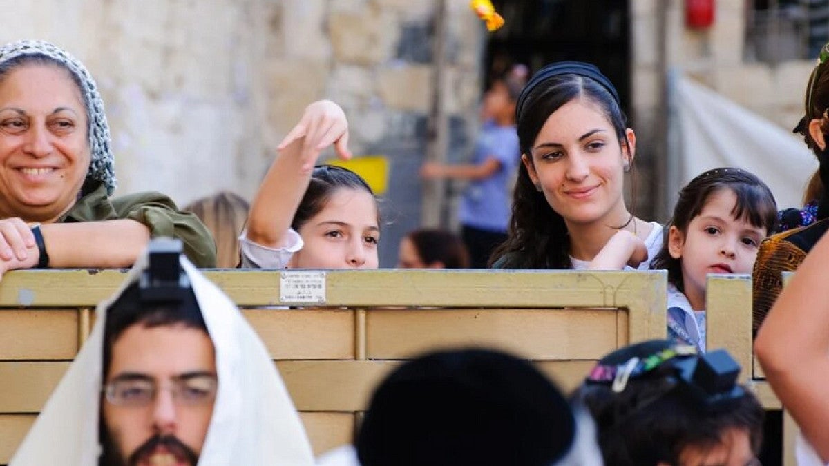 Woman and kids taking part in religious gathering