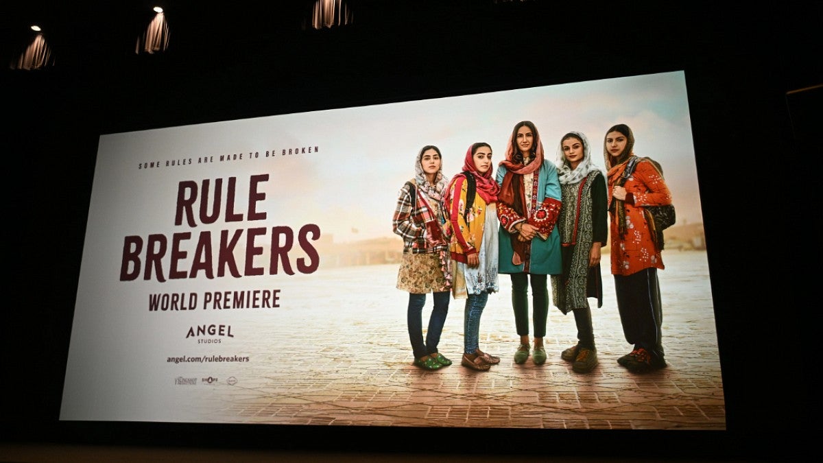 billboard with lights promoting Rule Breakers movie and featuring five Afghan women looking at the camera