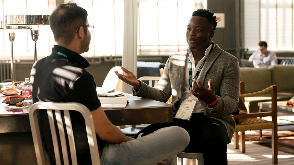 Two people having a discussion in an office setting.