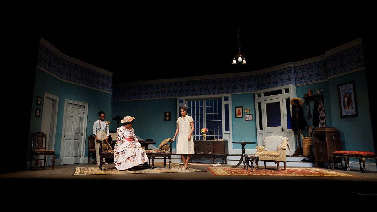 wide angle shot of three people on a stage