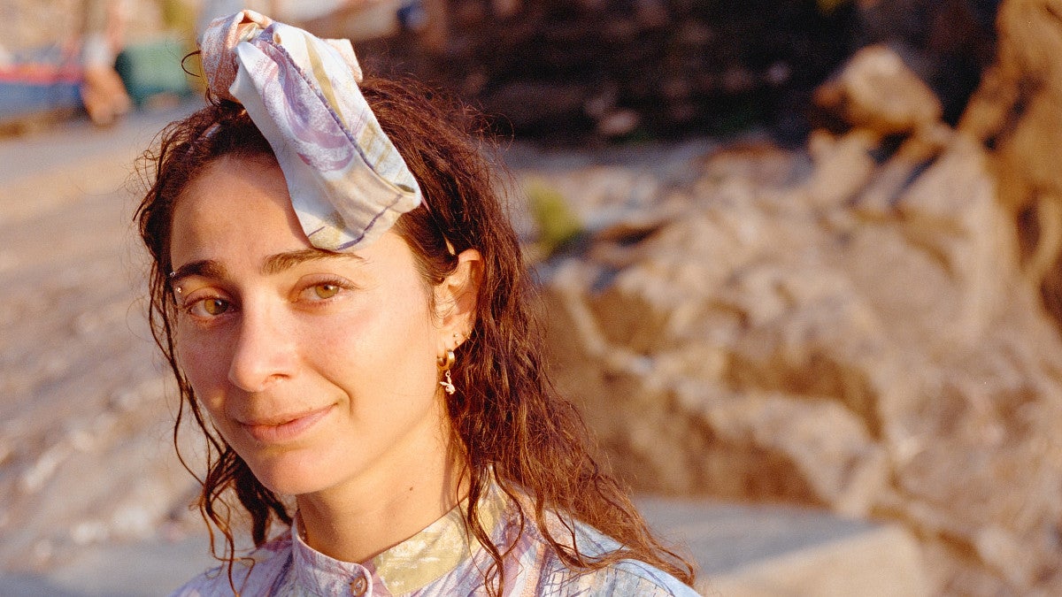 close up of alexi pappas wearing a headband and on a beach