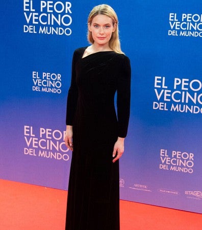 woman standing on red carpet in black gown