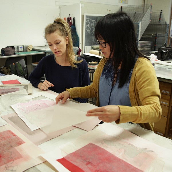 two people reviewing documents in art class