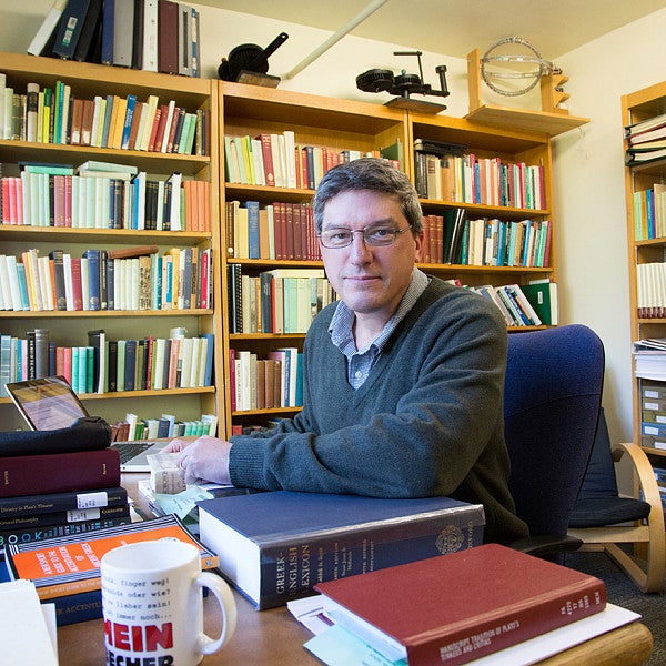 Malcom Wilson in faculty office with bookshelves