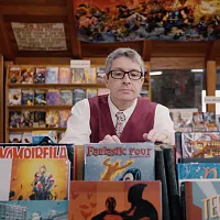 english professor ben saunders browsing comics in a store