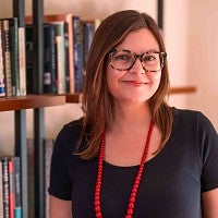 Karen Thompson Walker poses in front of a bookshelf