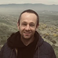 Man standing in front of wide open landscape