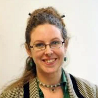Woman Smiling with glasses and pins in her hair