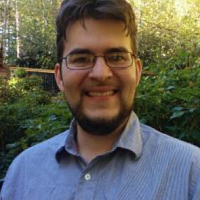 A Man with glasses smiling