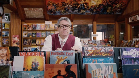 professor Ben Saunders browsing comic books in a store