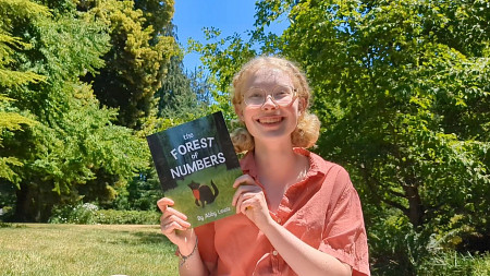Abby Lewis with her book