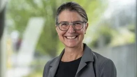 Picture of a woman wearing glasses smiling 